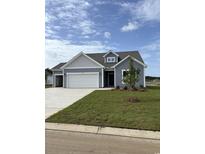 Charming single-Gathering home with a three-car garage, manicured lawn, and classic curb appeal at 180 Glengrove Lane, Murrells Inlet, SC 29576