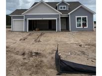 New construction home with gray siding, a two-car garage, and a covered entrance at 180 Glengrove Lane, Murrells Inlet, SC 29576