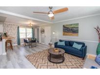 Inviting living room featuring modern furnishings, wood-look flooring, and a decorative ceiling fan at 1819 Martin Circle, Myrtle Beach, SC 29579