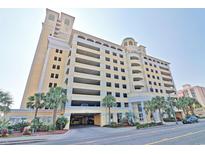 Camelot By The Sea resort featuring multi-level parking, palm trees, and lovely landscaping at 2000 N Ocean Blvd. # 1509, Myrtle Beach, SC 29577
