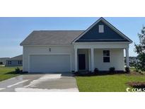 Charming one-story home with a two-car garage and a well-maintained lawn at 225 Carver Willow Dr., Loris, SC 29569