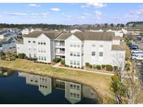 A scenic view of the condo complex reflecting on the tranquil waters of a pond at 2263 Andover Dr. # J, Surfside Beach, SC 29575