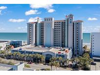 A multi-story hotel with parking garage access, palm trees, beach and ocean views under a sunny sky at 2311 S Ocean Blvd. # 771, Myrtle Beach, SC 29577