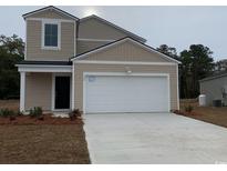 Charming two-story home featuring a two-car garage, neutral siding, and well-maintained landscaping at 264 Warner Crossing Way, Loris, SC 29569