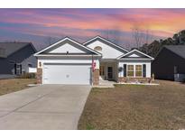Charming single Gathering home with a two-car garage and a cozy front lawn at 321 Cabo Loop, Myrtle Beach, SC 29588