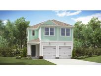 Charming two-story home with a two-car garage, green siding, and well-manicured landscaping at 3312 Beach Cottage Pl., North Myrtle Beach, SC 29582