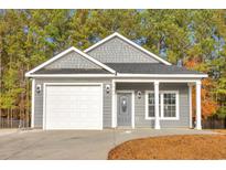 Charming single-story home features a gray exterior, attached garage, and well-maintained landscaping at 3837 Mayfield Dr., Conway, SC 29526