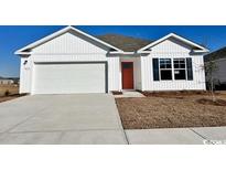 Charming single-Gathering home with a two-car garage, a red door, and bright white siding at 3866 Lady Bug Dr., Shallotte, NC 28470