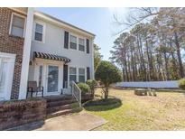 Charming townhome featuring a well-maintained lawn and inviting entrance, offering a blend of comfort and curb appeal at 4115 Little River Rd. # 4-F, Myrtle Beach, SC 29577