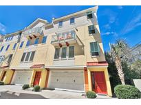 Charming multi-story townhouse with private balconies, red doors, and garages in a desirable neighborhood at 7401 N Ocean Blvd. # 5, Myrtle Beach, SC 29572