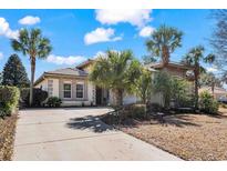 Charming single-story home featuring a well-maintained lawn, tropical palms and a tile roof at 7538 Ventura Ct., Myrtle Beach, SC 29572