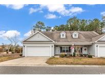 Charming single-story home with a well-maintained front yard and attached garage at 1018 Red Sky Ln. # 101, Murrells Inlet, SC 29576