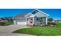 Charming single-story home with a well-manicured lawn, attached garage, and inviting red front door at 1525 Sunmeadow Dr., Conway, SC 29526