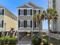 Charming two-story beach house with palm trees and beautiful ocean views in a relaxing neighborhood at 2000 N Waccamaw Dr., Garden City Beach, SC 29576