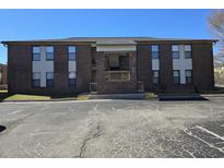 Brick apartment building with private entrance and parking lot in front under clear blue skies at 2005 Greens Blvd. # D3-05, Myrtle Beach, SC 29577