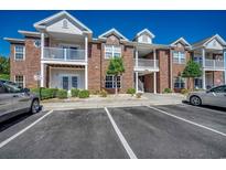 Brick condo building featuring multiple stories, white trim, and manicured landscaping at 2005 Silvercrest Dr. # 32-B, Myrtle Beach, SC 29579