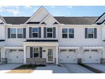 Charming white townhouse with a private garage and modern architectural details at 2352 Elowen Ln. # 22B, Longs, SC 29568