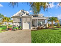 Charming home with a well-manicured lawn, two-car garage, and golf cart parked in the driveway at 3120 Moss Bridge Ln., Myrtle Beach, SC 29579