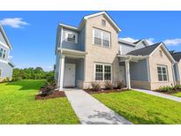 Charming two-story townhome with a combination of brick and siding and a well-manicured lawn and walkway at 344 Kiskadee Loop # A, Conway, SC 29526
