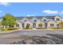 Beautiful condo building with blue and white accents, complemented by lush landscaping and designated parking at 344 Kiskadee Loop # B, Conway, SC 29526