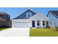 Charming two-story home with blue siding, a white garage door, and well-maintained green lawn at 4036 Bucolic Loop, Myrtle Beach, SC 29588