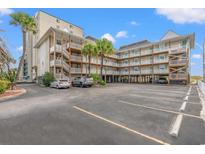 Well-maintained condo building with ample parking, beautiful palm trees, and stairs to upper levels at 4509 S Ocean Blvd. # A5, North Myrtle Beach, SC 29582