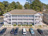 Well-maintained condo with a large parking lot and green landscaping at 4787 Wild Iris Dr. # 203, Myrtle Beach, SC 29577