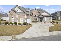 Charming brick home with a well-manicured lawn and a spacious driveway at 654 Evers Loop, Surfside Beach, SC 29575
