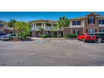 A well-maintained building exterior featuring a large parking lot and attractive landscaping at 700 Pickering Dr. # 103, Murrells Inlet, SC 29576