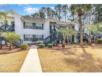 Inviting two-story townhouse with a well-maintained lawn and mature landscaping at 850 Fairway Dr. # 1003Ee, Longs, SC 29568