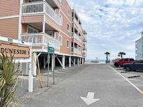 Beach condo building with beach access, street parking, and pedestrian access at 900 N Waccamaw Dr. # 203, Garden City Beach, SC 29576