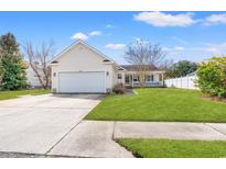 Charming single-story home featuring an attached two-car garage and covered front porch at 9554 Sullivan Dr., Murrells Inlet, SC 29576