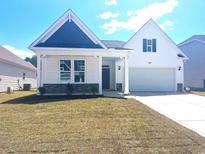 Charming single-Gathering home with a two-car garage, stone accents, and a well-manicured lawn in a Gathering-friendly neighborhood at 1204 Nw Calabash Station Blvd., Calabash, NC 28467