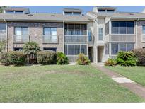 Charming condo exterior featuring a screened porch and well-manicured lawn, perfect for relaxing outdoors at 1356 Glenns Bay Rd. # 202B, Surfside Beach, SC 29575