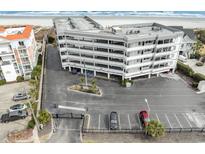 Multi-level condo building near the beach with ample parking and meticulous landscaping at 1581 S Waccamaw Dr. # 402, Garden City Beach, SC 29576