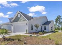 Charming two-story home featuring an attached two-car garage and well-maintained lawn and landscaping at 205 Kinross Ct., Little River, SC 29566