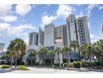 Lovely condo building with many floors, tropical foliage and covered parking entrance at 2311 S Ocean Blvd. # 241, Myrtle Beach, SC 29577