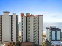 Exterior of a beachfront condo with balconies and ocean views on a sunny day at 2701 N Ocean Blvd. # 1053, Myrtle Beach, SC 29577