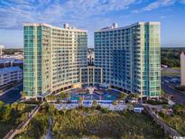 Stunning aerial view of luxury condo complex with beach access and a sparkling pool at 300 N Ocean Blvd. # 406, North Myrtle Beach, SC 29582