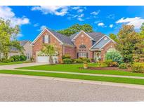 Charming brick home boasts a well-manicured lawn and a tidy, attached two-car garage at 3120 Bayhaven Dr., Myrtle Beach, SC 29579