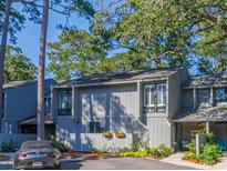 Charming multi-level home with landscaped yard and a gray car parked in front at 320 Salt Marsh Circle # 8-B, Pawleys Island, SC 29585
