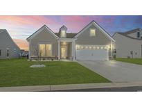 Charming single Gathering home with a manicured lawn, neutral siding, and a two car garage at 3215 Preciado Dr., Myrtle Beach, SC 29579