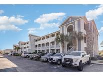 Condominium complex featuring a large parking lot and multiple floors with balconies at 4503 W Harbour Ct. # S-6, Little River, SC 29566
