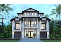 Stunning three-story home featuring a sleek modern design with meticulously landscaped grounds and a grand entrance at 4710 Surf St., North Myrtle Beach, SC 29582