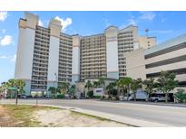 A full shot of the Beach Cove Resort building with a parking garage on the right side at 4800 S Ocean Blvd. # 204, North Myrtle Beach, SC 29582