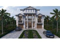 Stunning new construction home featuring a symmetrical facade, second-story balconies, and lush landscaping at 4710 Surf St., North Myrtle Beach, SC 29582