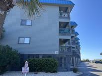 Exterior shot of a condo building with private balconies and parking at 6000 N Ocean Blvd. # 122, North Myrtle Beach, SC 29582