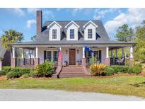 Charming two-story home with a inviting front porch, beautiful landscape, and brick accents at 96 Chippewa Ln., Georgetown, SC 29440