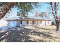 Charming single-story home with a welcoming front porch, a two car garage, and a well-maintained lawn at 103 Station St., Longs, SC 29568