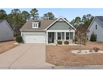 Charming single-Gathering home featuring a two-car garage, manicured lawn, and inviting front porch at 109 Astoria Park Loop, Conway, SC 29526